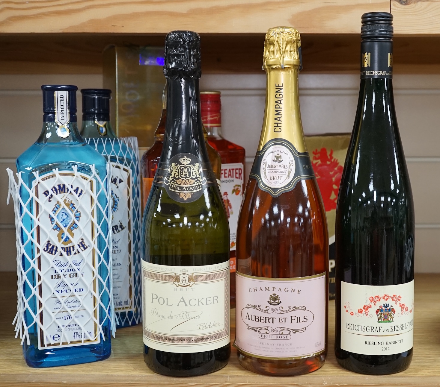 Nine various bottles of wine and spirits to include Albert Et Fils champagne, Bells Scotch whisky and Bombay Sapphire gin. Condition - good, storage history unknown